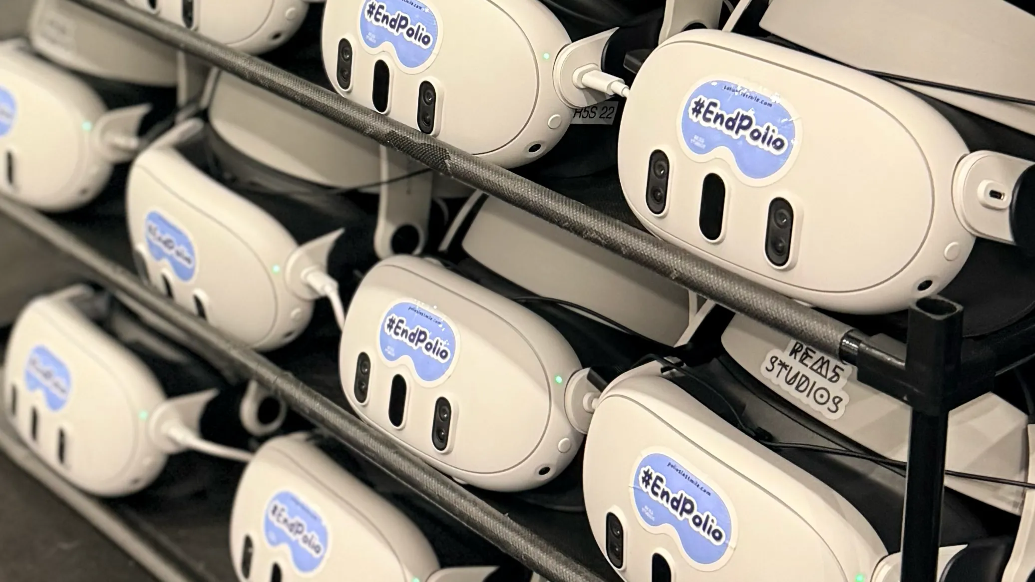 Shelves of VR headsets marked #EndPolio, charged and racked for the next wave of Rotary 2026 attendees